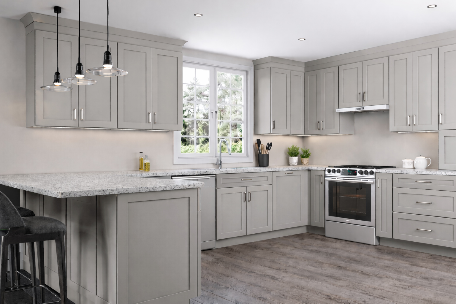 Bright kitchen featuring custom grey shaker cabinets, a large white island, gold hardware, and glass pendant lighting.