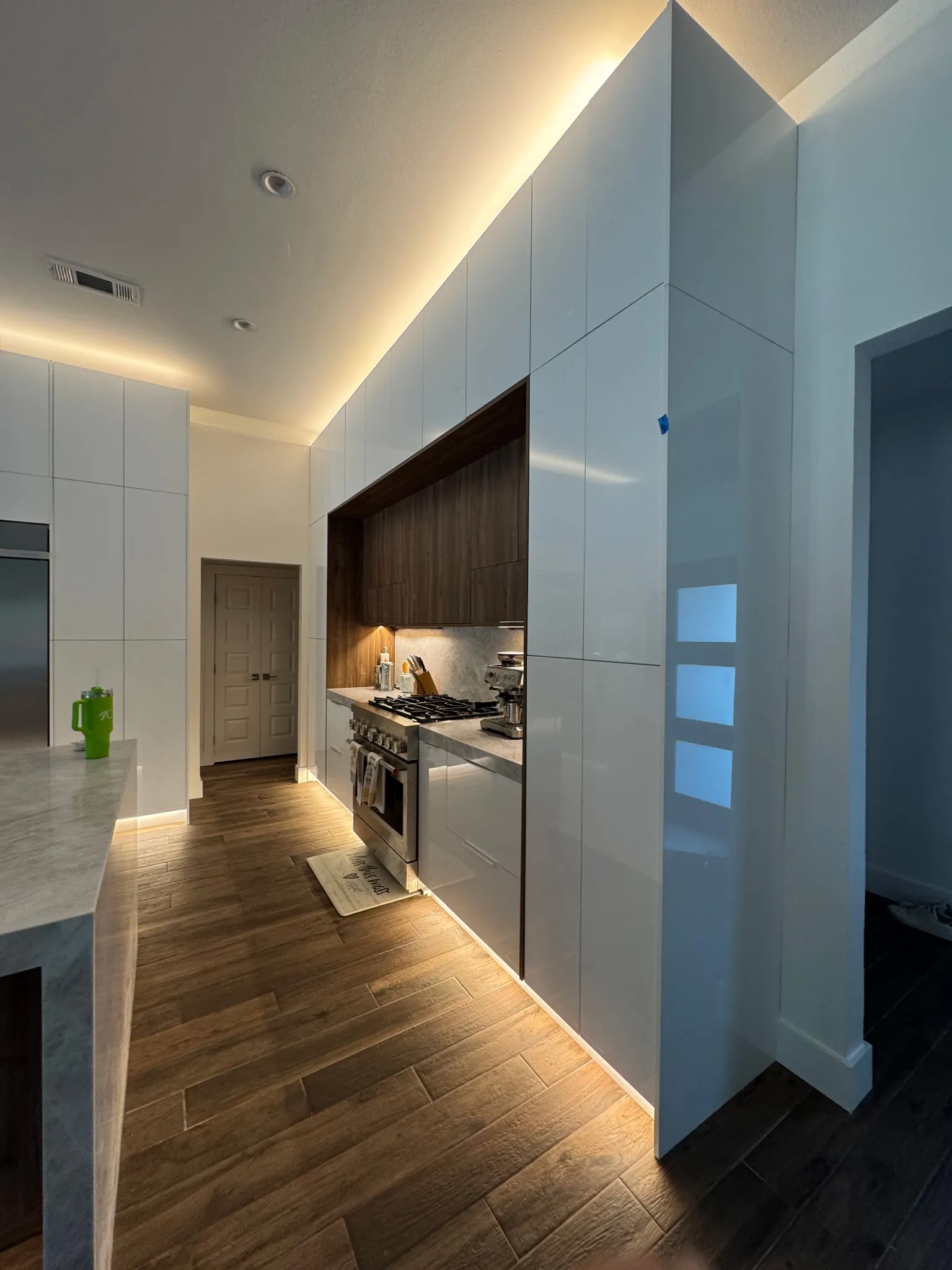 Modern white custom built-in closet system with hanging space and storage shelves