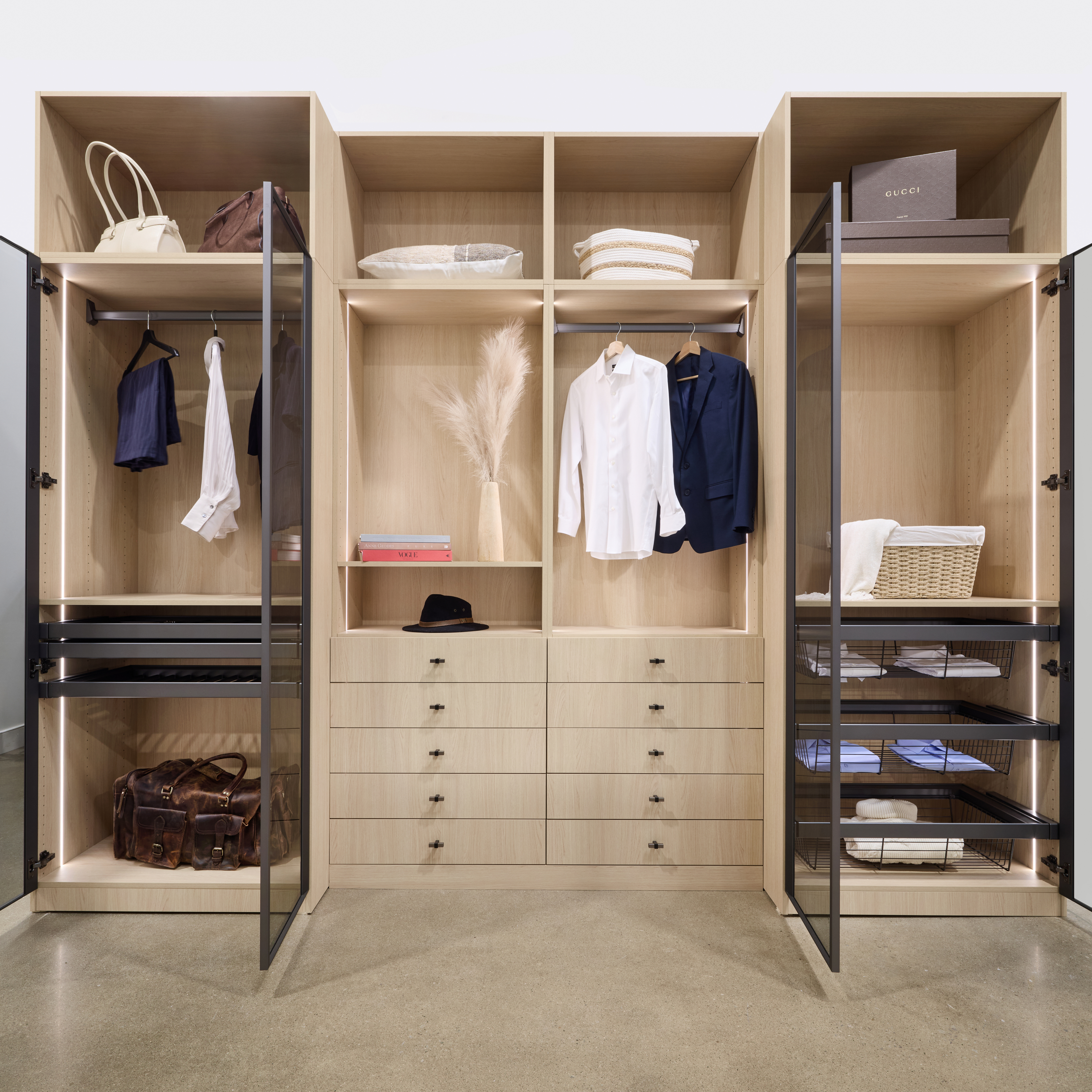 Large custom walk-in closet system featuring dedicated open shelving for shoes, integrated drawers, and multiple hanging rods.