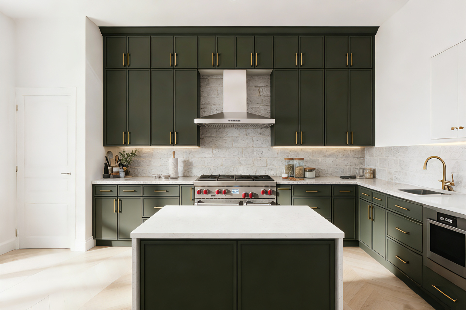 Modern kitchen featuring custom slim green shaker cabinets, a contrasting white island, and gold hardware.