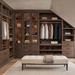Wholesale custom dark wood closet system built under a sloped ceiling with integrated display lighting.
