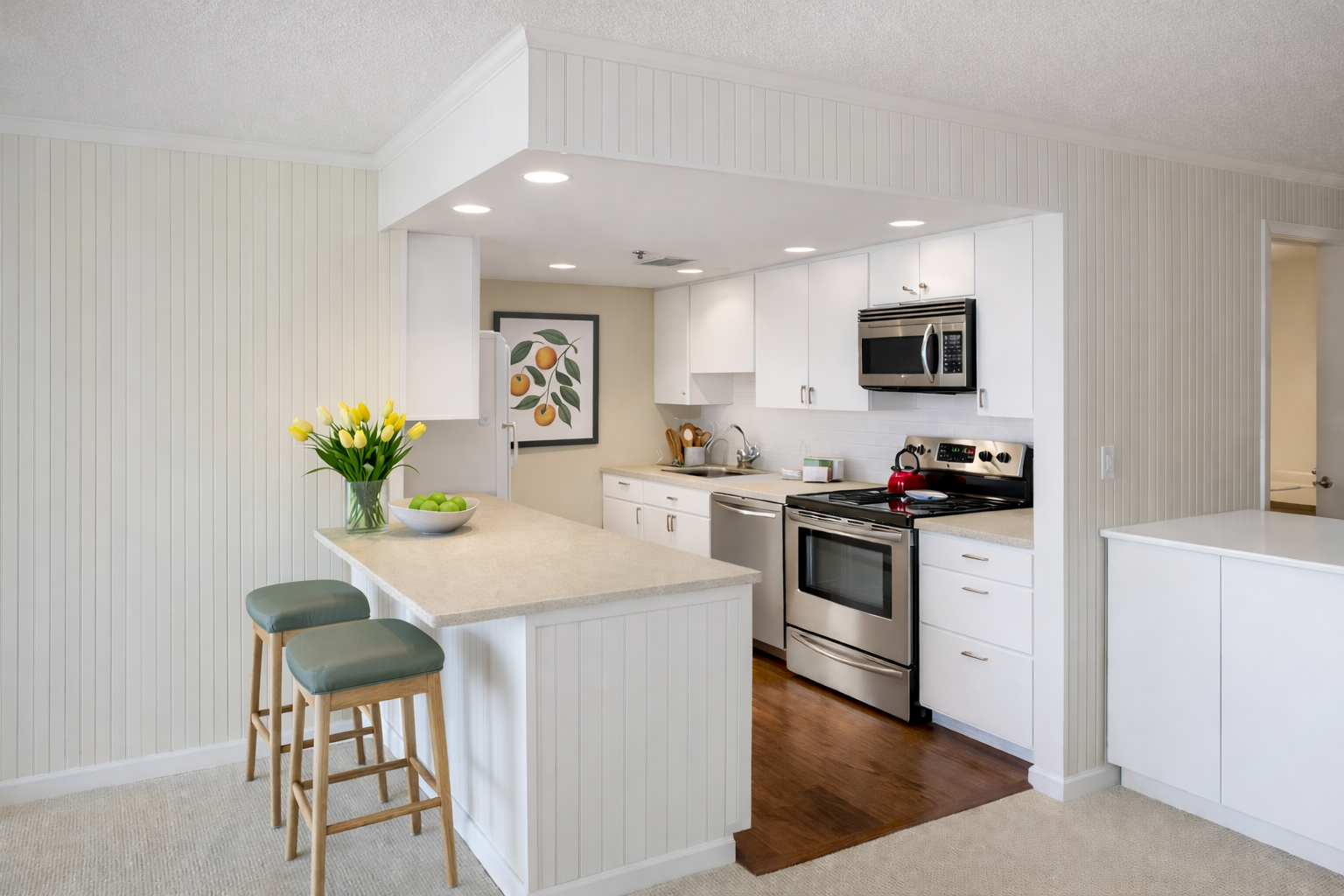 Bright kitchen island with flat-panel matte white frameless cabinets and chic globe pendant lights overhead.