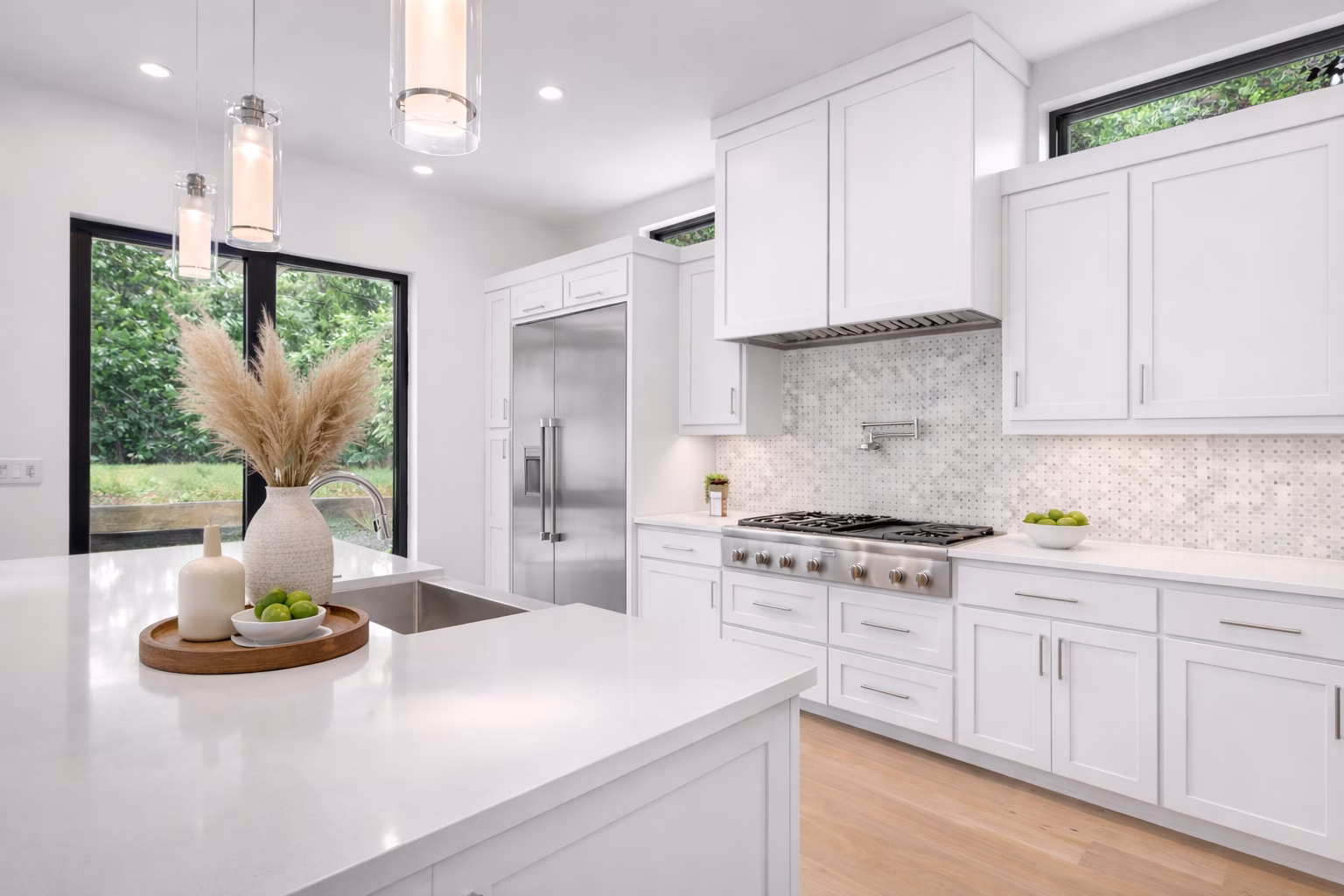 Spacious open-concept kitchen featuring white shaker cabinets and a central kitchen island.