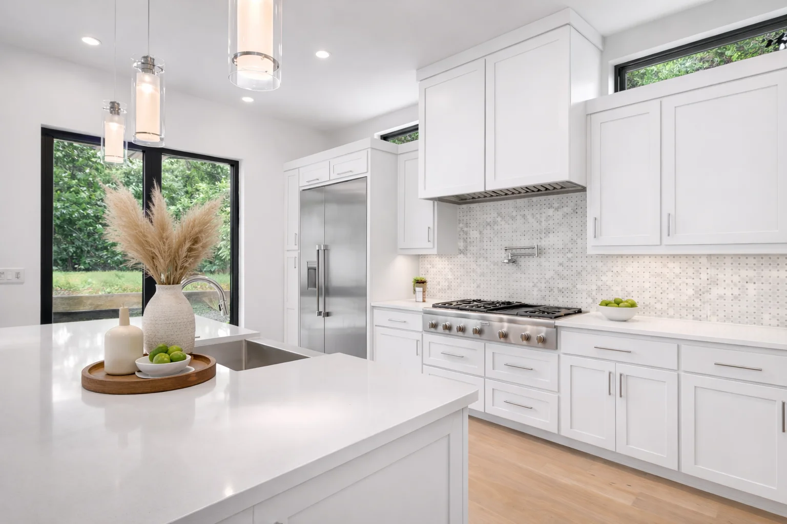 Spacious open-concept kitchen featuring white shaker cabinets and a central kitchen island.